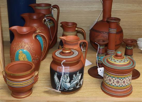 A collection of Etruscan-style redware, including a black-figured bottle-shaped vase,
